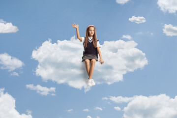 Poster - Girl in a school uniform sitting on a cloud