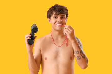 Sticker - Male lifeguard with whistle and binoculars on yellow background