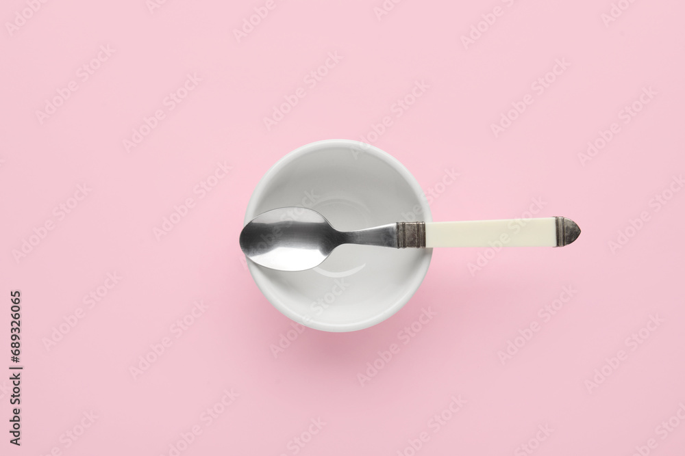 Bowl and spoon on pink background Stock Photo | Adobe Stock