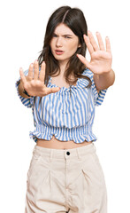 Poster - Young beautiful caucasian girl wearing casual clothes doing stop gesture with hands palms, angry and frustration expression