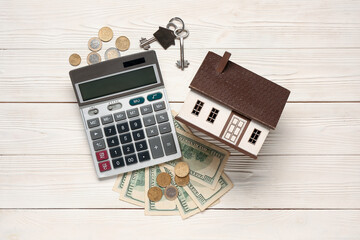 Poster - Calculator, house model, keys and money on light wooden background. Mortgage concept