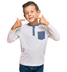 Wall Mural - Adorable caucasian kid wearing casual clothes smiling cheerful showing and pointing with fingers teeth and mouth. dental health concept.