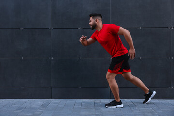 Sticker - Happy man running near building outdoors. Space for text