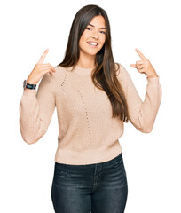 Wall Mural - Young brunette woman wearing casual winter sweater smiling pointing to head with both hands finger, great idea or thought, good memory