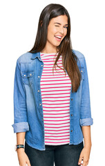 Canvas Print - Young brunette woman wearing casual clothes winking looking at the camera with sexy expression, cheerful and happy face.