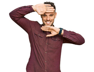 Poster - Young hispanic man wearing casual clothes smiling cheerful playing peek a boo with hands showing face. surprised and exited