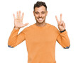 © Krakenimages.com - Young hispanic man wearing casual clothes showing and pointing up with fingers number seven while smiling confident and happy.