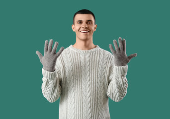 Sticker - Young man in knitted sweater on green background