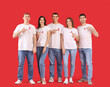 © Pixel-Shot - Group of young people with red ribbons on color background. World AIDS day concept