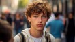 Cool sad lonely young American guy standing at city street. Stylish serious pensive sensitive vulnerable ethnic rebel hipster gen z teen boy looking at camera outdoors, close up portrait.