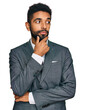 © Krakenimages.com - Young african american man wearing business clothes with hand on chin thinking about question, pensive expression. smiling with thoughtful face. doubt concept.