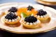 Closeup of natural black caviar served on crackers on black background, texture of fresh sturgeon caviar macro photo.