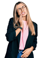 Sticker - Hispanic young woman wearing business jacket and glasses touching mouth with hand with painful expression because of toothache or dental illness on teeth. dentist