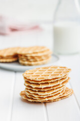 Poster - Round waffle biscuits on white table.