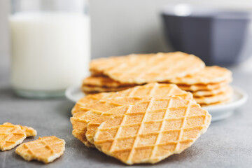 Poster - Round waffle biscuits on kitchen table.