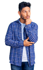 Sticker - Handsome latin american young man wearing casual shirt serious face thinking about question with hand on chin, thoughtful about confusing idea