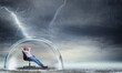 © alphaspirit - Businesswoman is relaxing during a storm as concept of insurance and protection