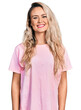 © Krakenimages.com - Young blonde woman wearing casual pink t shirt with a happy and cool smile on face. lucky person.