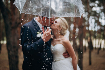 romantic newlyweds under umbrella. selective focus