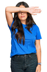 Sticker - Beautiful brunette young woman wearing casual clothes covering eyes with arm, looking serious and sad. sightless, hiding and rejection concept