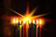 Closeup of Hanukkah menorah, or hanukkiah for Jewish holiday Hanukkah. Nine colored candles.