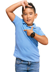 Wall Mural - Little boy hispanic kid wearing casual clothes smiling making frame with hands and fingers with happy face. creativity and photography concept.