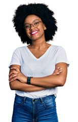 Wall Mural - Young african american woman wearing casual white t shirt happy face smiling with crossed arms looking at the camera. positive person.