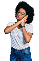 Sticker - Young african american woman wearing casual white t shirt sleeping tired dreaming and posing with hands together while smiling with closed eyes.