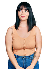 Sticker - Young hispanic plus size woman wearing casual clothes smiling looking to the side and staring away thinking.