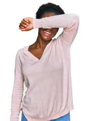 Wall Mural - Young african american girl wearing casual clothes covering eyes with arm smiling cheerful and funny. blind concept.
