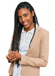 © Krakenimages.com - African american woman wearing business jacket with hands together and crossed fingers smiling relaxed and cheerful. success and optimistic