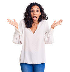 Canvas Print - Middle age beautiful woman wearing casual sweater celebrating crazy and amazed for success with arms raised and open eyes screaming excited. winner concept