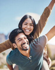 cheerful young adult couple on vacation in mountains, woman leans on man's back while they open arms