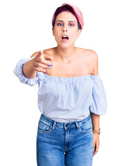 Poster - Young beautiful woman with pink hair wearing casual clothes pointing displeased and frustrated to the camera, angry and furious with you