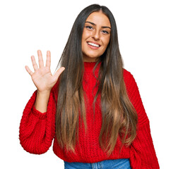 Sticker - Beautiful hispanic woman wearing casual clothes showing and pointing up with fingers number five while smiling confident and happy.