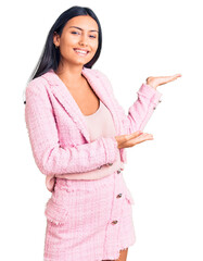 Wall Mural - Young beautiful latin girl wearing business clothes inviting to enter smiling natural with open hand