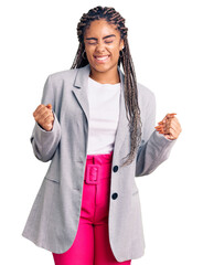 Sticker - Young african american woman with braids wearing business clothes excited for success with arms raised and eyes closed celebrating victory smiling. winner concept.