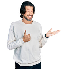 Poster - Middle age caucasian man wearing casual clothes showing palm hand and doing ok gesture with thumbs up, smiling happy and cheerful