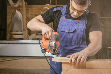 Wall Mural - A carpenter using a jigsaw to cut wood cuts bars. Home repair concepts, close up.