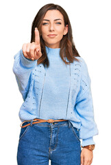 Poster - Young brunette woman wearing casual winter sweater pointing with finger up and angry expression, showing no gesture