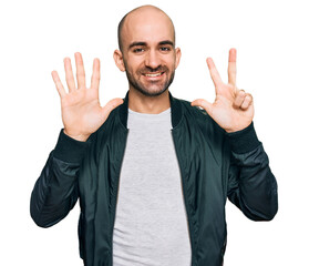 Poster - Young hispanic man wearing casual clothes showing and pointing up with fingers number eight while smiling confident and happy.