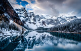 Fototapeta Góry - Frozen Serenity, A Captivating Winter Storm Blanketing a Tranquil Lake