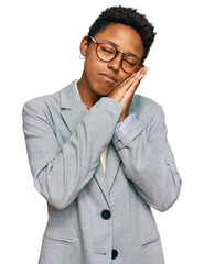 Wall Mural - Young african american woman wearing business clothes sleeping tired dreaming and posing with hands together while smiling with closed eyes.