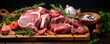 Lamb meat chops on wooden tray with green herbs and spices.