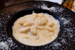 Classic gnocchi ai 4 formaggi, four cheese pasta, covered with parmesan and served on black plate 