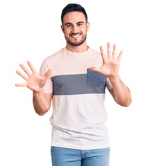 Wall Mural - Young handsome man wearing casual clothes showing and pointing up with fingers number ten while smiling confident and happy.