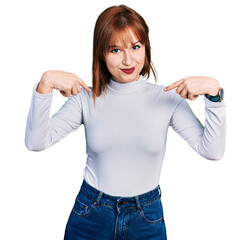Wall Mural - Redhead young woman wearing casual turtleneck sweater looking confident with smile on face, pointing oneself with fingers proud and happy.