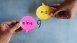 © izzuan - Hand holding speech bubble with text NINE and SIX. Different perception, perspective and argument