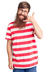 Canvas Print - Handsome young red head man with long beard wearing casual clothes smiling doing phone gesture with hand and fingers like talking on the telephone. communicating concepts.