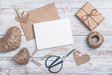 Craft Envelope, Blank Form, Heart Shapes Made Of Burlap And Twine, Scissors And A Craft Gift Box On A Wooden Background. DIY Gifts.